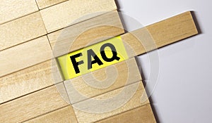 FAQ word written on wood block, concept