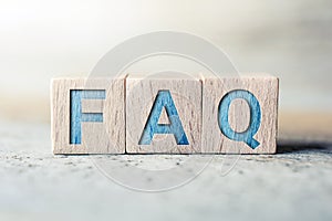 FAQ Written On Wooden Blocks On A Board - Need Help Concept