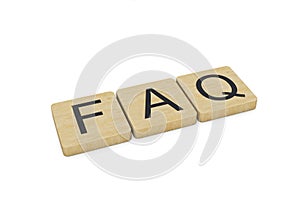 FAQ written with wooden letters, isolated on white background