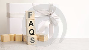 faqs text on a wooden cubes on a white paper background