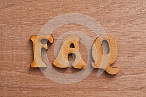 FAQs wooden background.