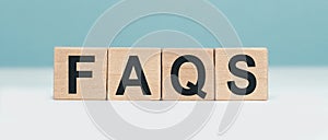 FAQS - word concept from wooden blocks on blue background