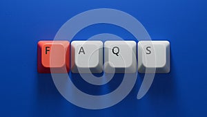 faqs word written on Computer keyboard keys with copy space.close up of Computer keyboard keys