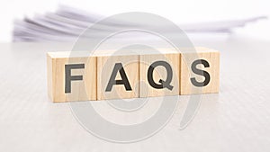 faqs word written on wood cubes with white background