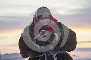 Far north, tundra, a girl-helper of the reindeer herder, a girl in national clothes, portrait