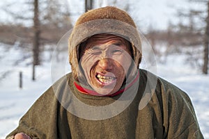 Far north of Yamal, tundra, pasture nord reindeers, closeup portrait of Nenets at age, close-up portrait of Nenets in national