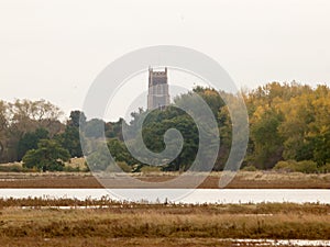 Far off church top spire overcast river coast