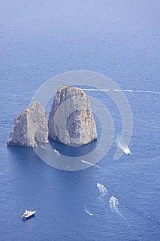 Faraglioni, attractive coastal rock formation eroded by waves, Capri, Italy