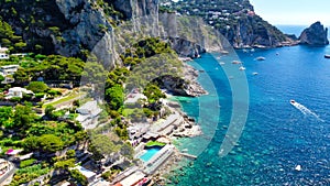 Faraglioni from Marina Piccola Beach in Capri, Italy. Aerial view from drone