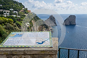 Faraglioni rocks view and tourist`s information. Capri island.