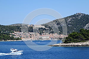 A faraway view from the ferry of the town of Hvar, on Hvar Island, Croatia.  It is a beautiful sunny summer day