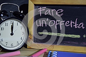 Fare un`offerta in italian on phrase colorful handwritten on blackboard. photo