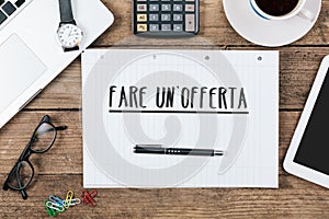 Fare un`offerta, Italian text for Make an offer on note pad at o photo