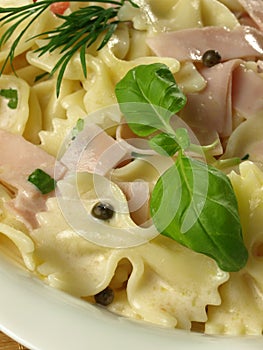Farfalle pasta with ham - closeup.