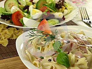 Farfalle pasta with ham on a plate