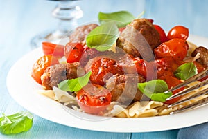 Farfalle pasta with meatballs and tomatoes