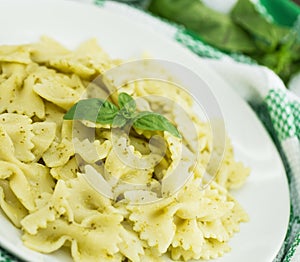 Farfalle pasta with pesto genovese basil sauce on white rusti