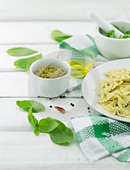 Farfalle pasta with pesto genovese basil sauce on white rusti