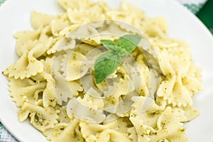 Farfalle pasta with pesto genovese & x28;basil sauce& x29; on rustic wood