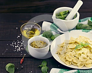 Farfalle pasta with pesto genovese & x28;basil sauce& x29; on rustic wood