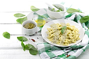 Farfalle pasta with pesto genovese & x28;basil sauce& x29; on white rusti