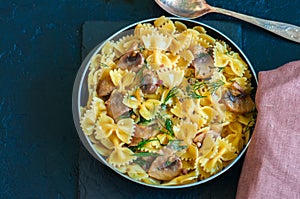 Farfalle pasta in sour cream sauce with mushrooms garnished with