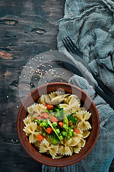 Farfalle pasta with vegetables on the plate.