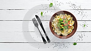 Farfalle pasta with vegetables on the plate.