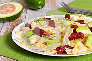 Farfalle Pasta warm salad with avocado slices and smoked sausage
