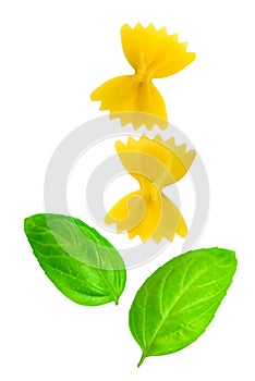 Farfalle or short pasta and oregano leaf isolated on white background
