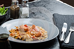 Farfalle with tomato sauce and roasted salmon