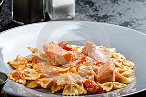 Farfalle with tomato sauce and roasted salmon