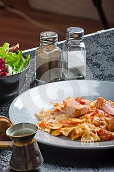 Farfalle with tomato sauce and roasted salmon