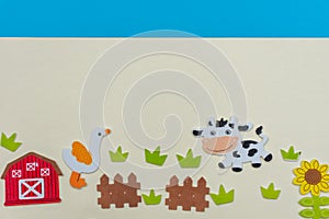 Farm animals on a flat lay with cows, grass, fence, blue sky, flowers and a farm house on a white background