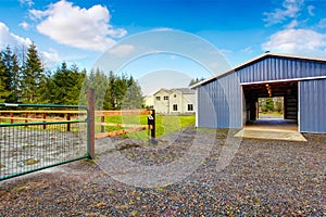 Farm blue barn shed and gravel driveway.