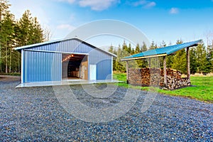 Farm blue barn shed and gravel driveway.