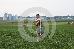 Farm boy running through field