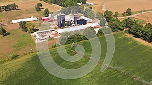 Farm buildings and green soybean fields , agricultural landscape. Aerial view.