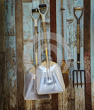 Farm cart ifarm tool pitchfork and two shovels against old wooden wall use as rural farm scene solated white background