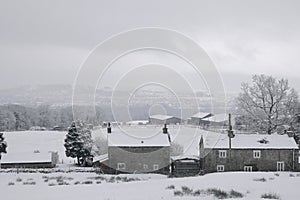 Farm cottages covered with snow.