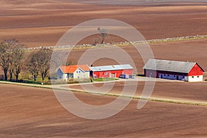 Farm in the countryside with newly sown fields