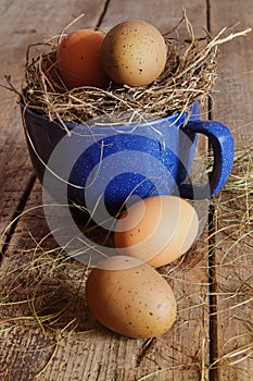 Farm eggs in blue cup with straw