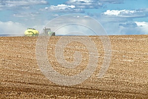 Farm equipment planting wheat in the fertile farm fields of Idaho.