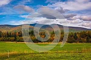 Farm field and autumn color in the White Mountains near Jefferson, New Hampshire.