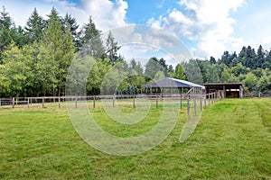 Farm field with empty horse barn