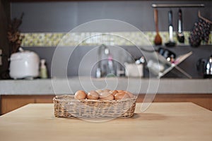 Farm-fresh eggs piled up in wooden baskets in the home`s kitchen