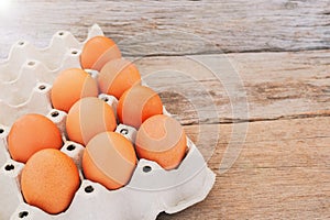 Farm fresh eggs placed in the hens nest on the wooden floor.