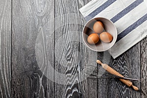 Farm fresh organic large brown and white eggs in egg carton on rustic dark oak wood background table.