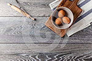 Farm fresh organic large brown and white eggs in egg carton on rustic dark oak wood background table.