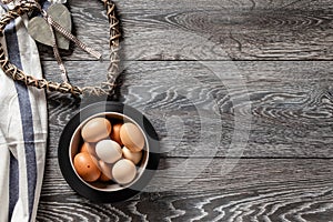 Farm fresh organic large brown and white eggs in egg carton on rustic dark oak wood background table.